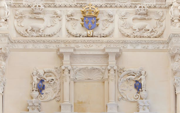 Ornate stone carvings with fleur-de-lis emblem at Cité internationale de la langue française.