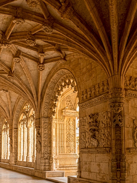 Jeronimos Monastery cloister with intricate vaulted ceiling, Lisbon, Portugal.