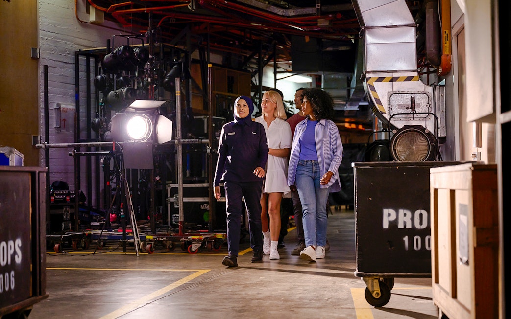 Backstage tour group at Sydney Opera House with guide.