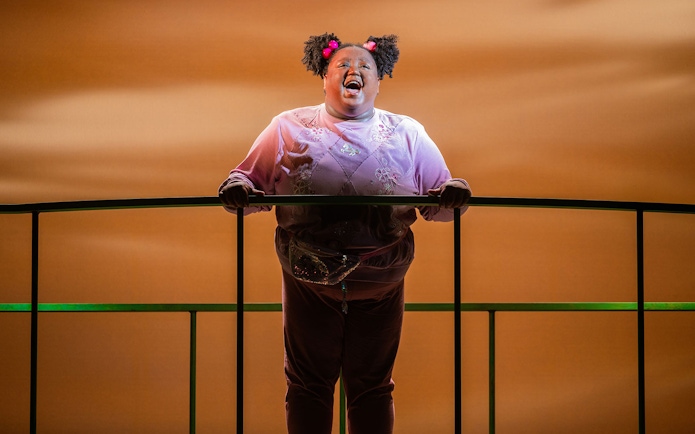 Performer singing on stage in Heathers: The Musical.