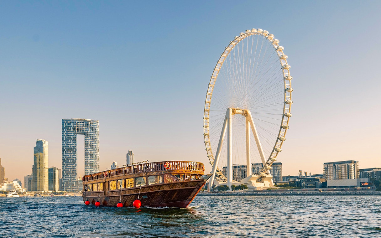 Dhow cruise near Dubai Marina with Ain Dubai Ferris wheel in the background.