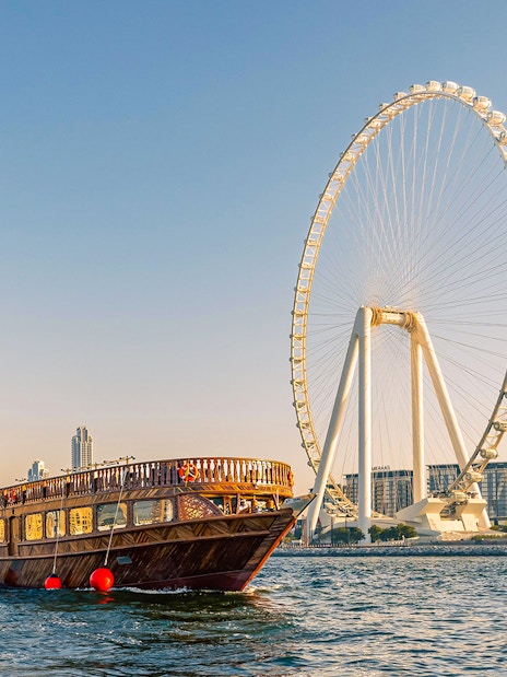 Dhow cruise near Dubai Marina with Ain Dubai Ferris wheel in the background.