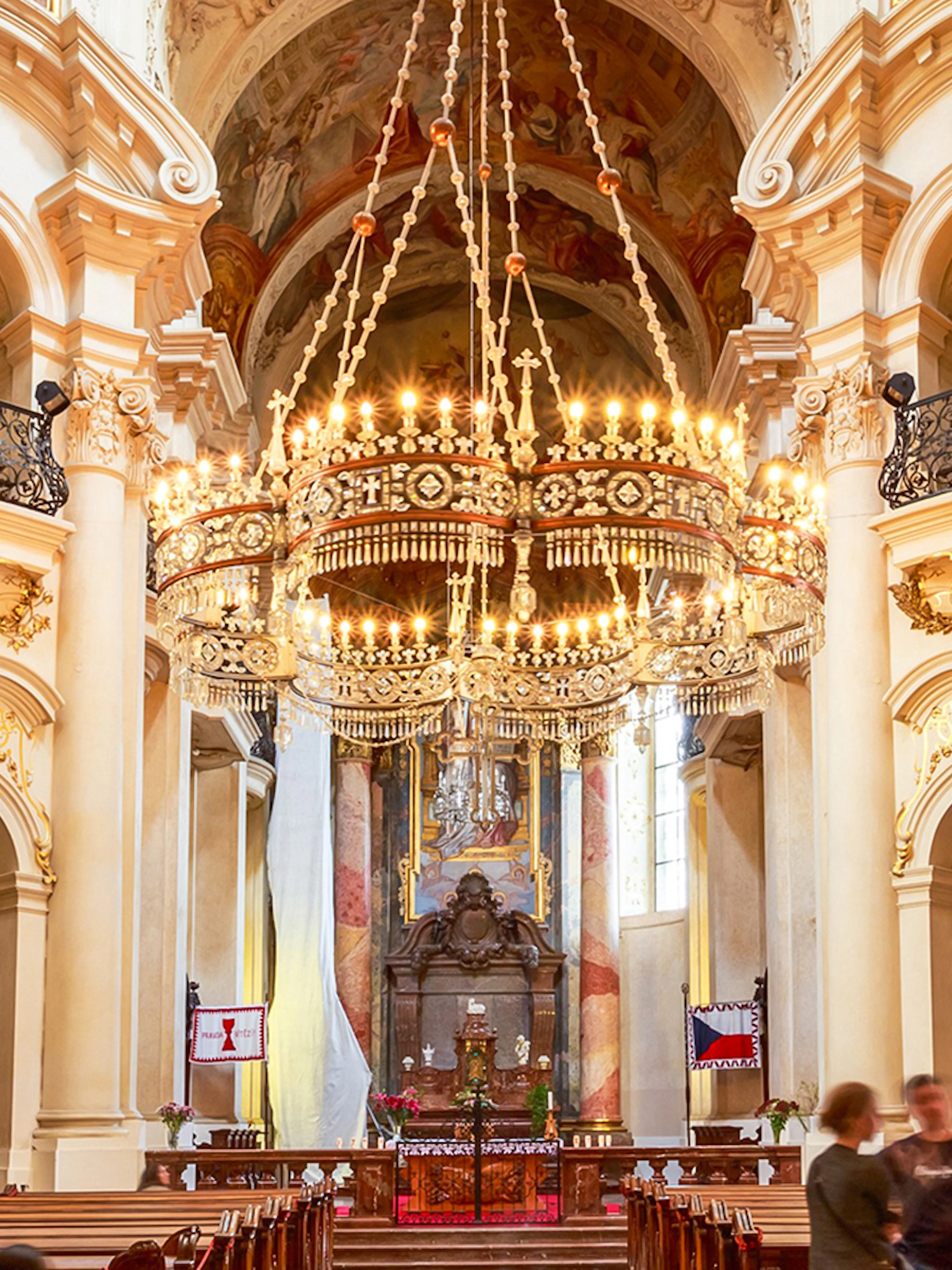 St. Nicholas Church interior with ornate chandelier, Prague classical concert setting.
