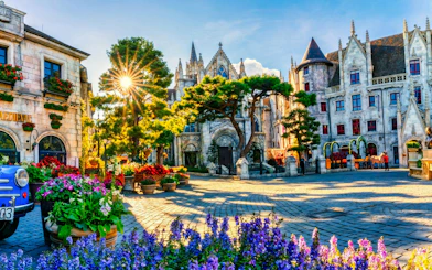 French Village square with medieval architecture and colorful flowers, Sun World Ba Na Hills, Da Nang.
