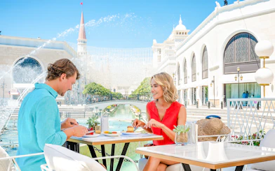 Lunch at The Land of Legends theme park with a view of fountains and architecture.