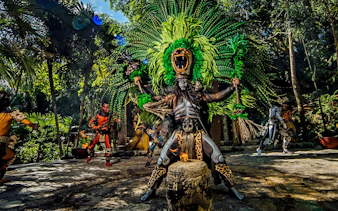 Traditional Mayan performance at Xcaret Park with dancers in vibrant costumes.