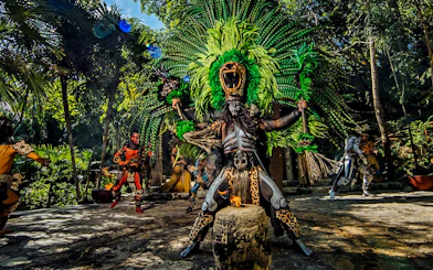 Traditional Mayan performance at Xcaret Park with dancers in vibrant costumes.