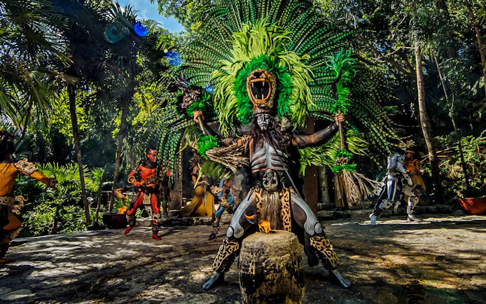 Traditional Mayan performance at Xcaret Park with dancers in vibrant costumes.