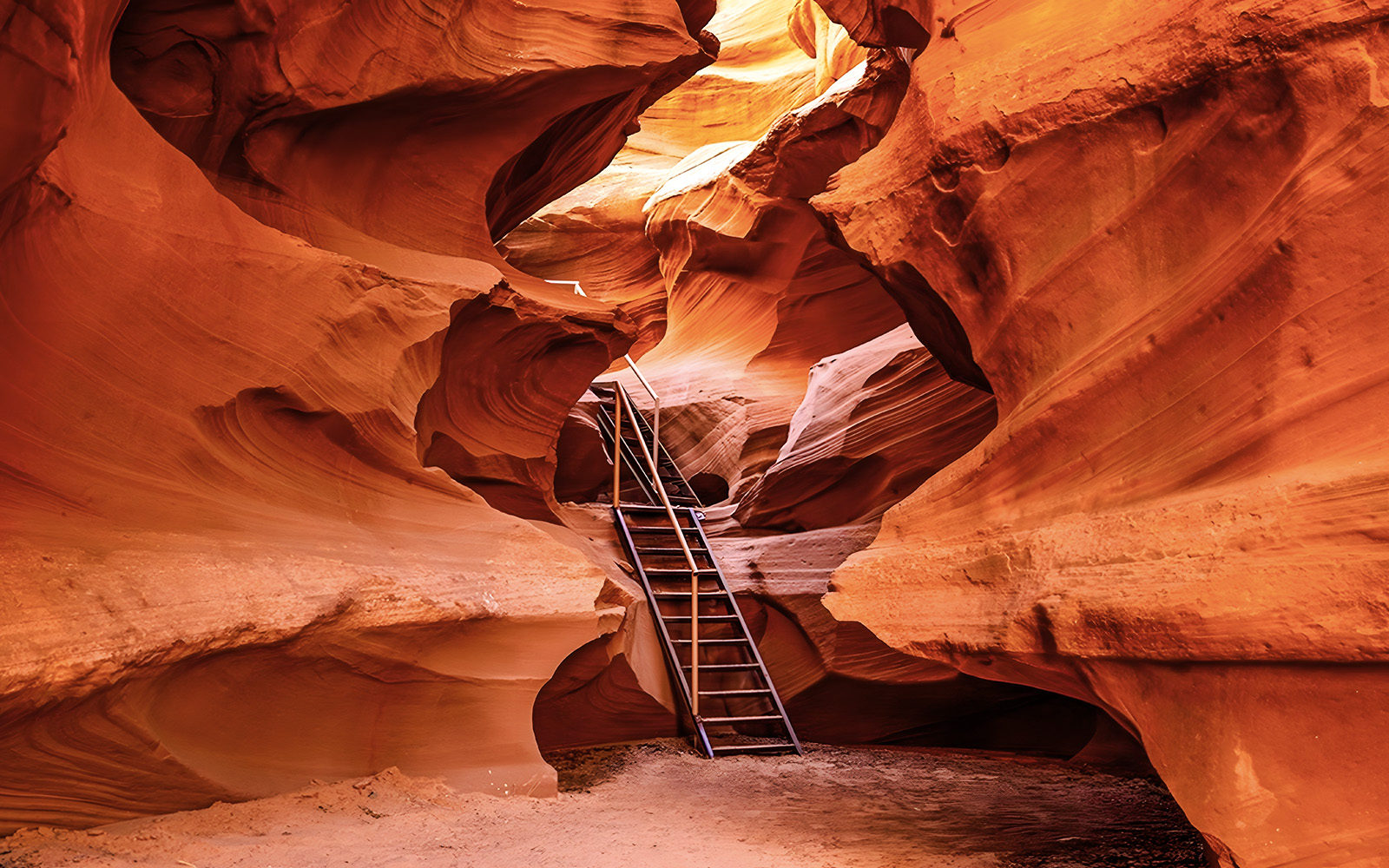 Ladder leading through narrow sandstone formations in Waterhole Canyon.