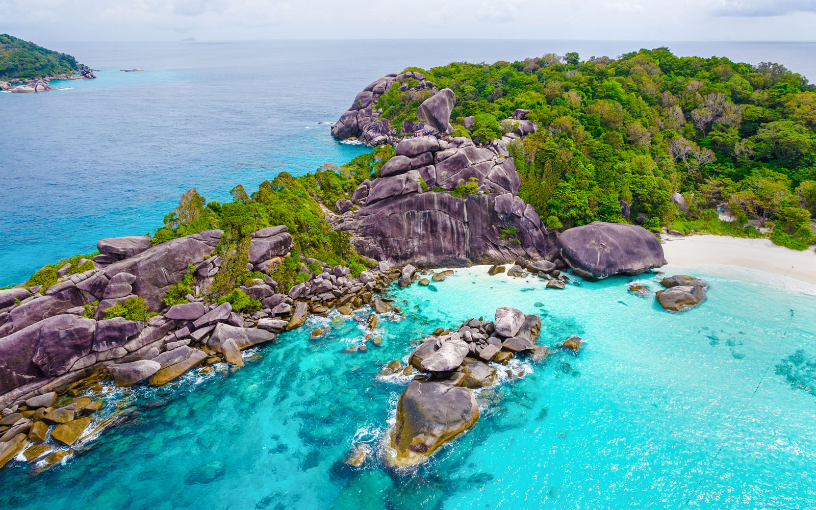 Aerial view of Similan Island's rocky coastline and turquoise waters.