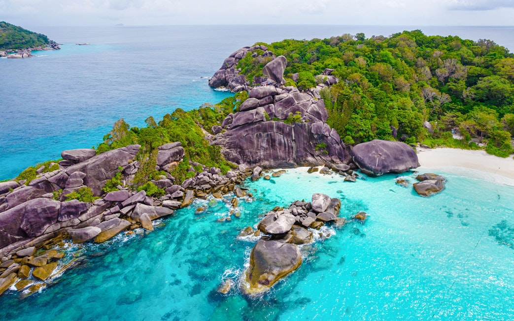 Aerial view of Similan Island's rocky coastline and turquoise waters.