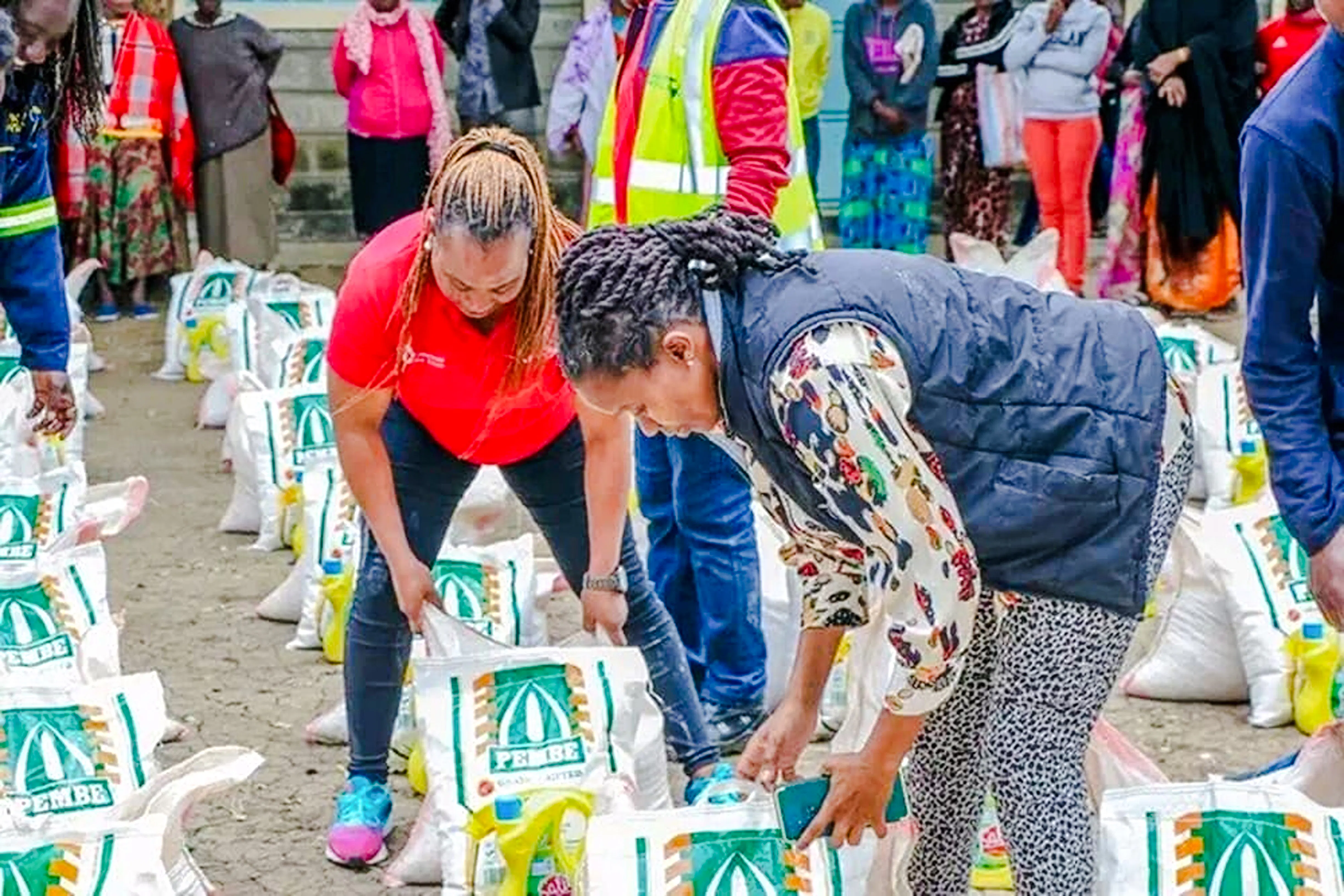 Locals distributing food supplies during Kibera Slum storytelling tour in Nairobi.