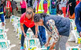 Locals distributing food supplies during Kibera Slum storytelling tour in Nairobi.