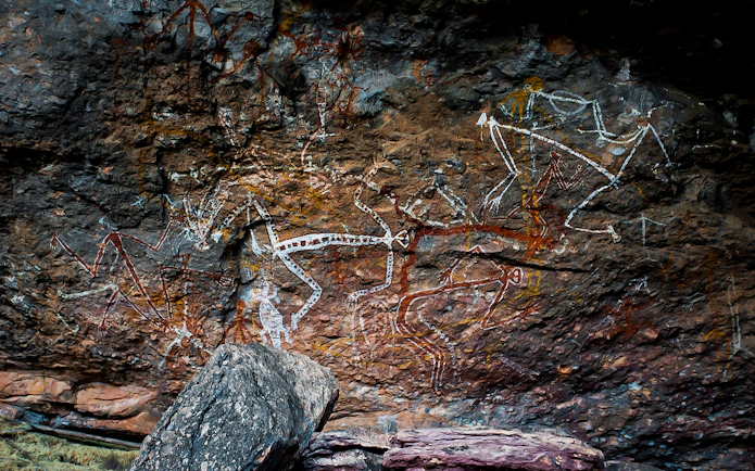 Rock art at Kakadu National Park, Australia, depicting ancient Aboriginal figures.