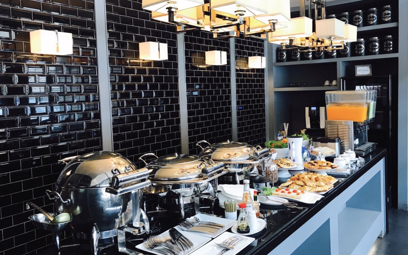 Buffet spread at The Coral Executive Lounge, Phuket International Airport, featuring pastries and beverages.