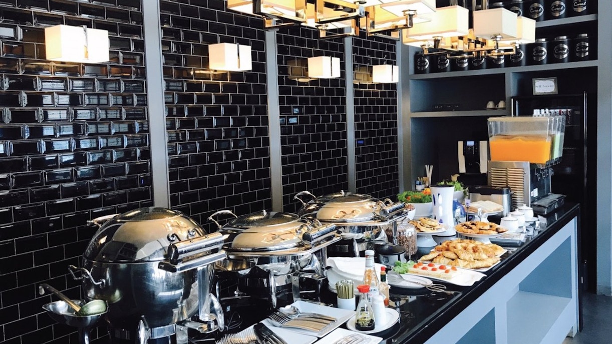 Buffet spread at The Coral Executive Lounge, Phuket International Airport, featuring pastries and beverages.