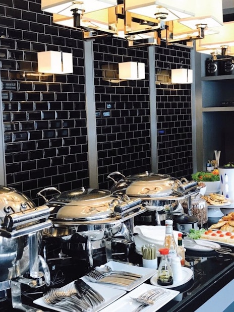 Buffet spread at The Coral Executive Lounge, Phuket International Airport, featuring pastries and beverages.