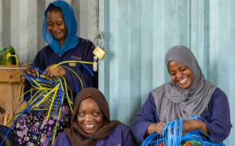 Women weaving baskets during an upcycling workshop in Stone Town, Zanzibar.