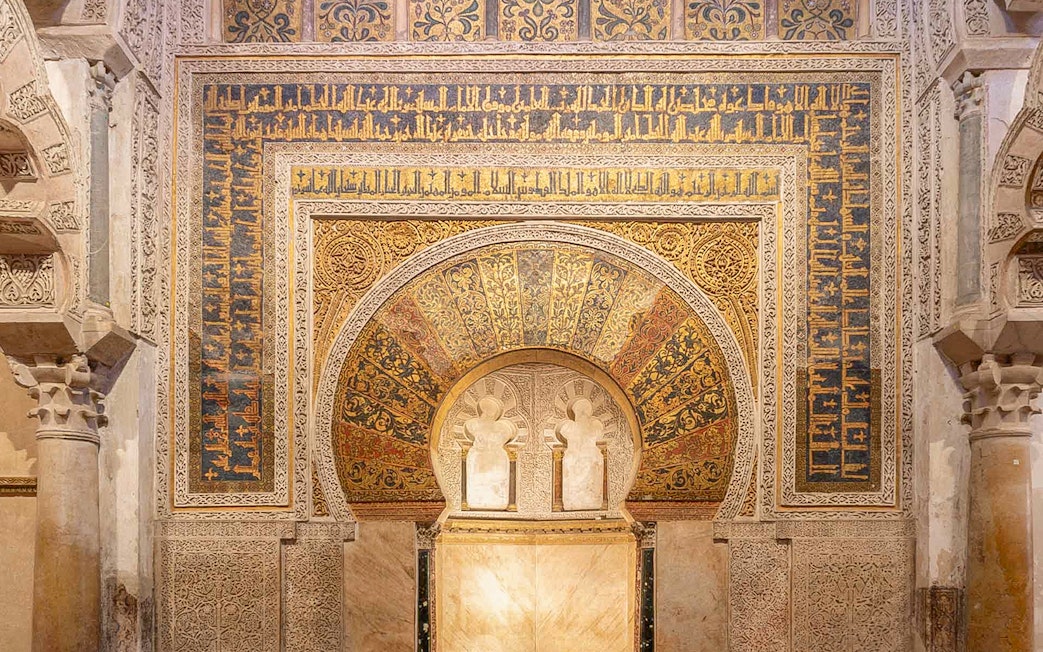 Intricate archway with Arabic calligraphy in Cordoba Mosque, Spain.