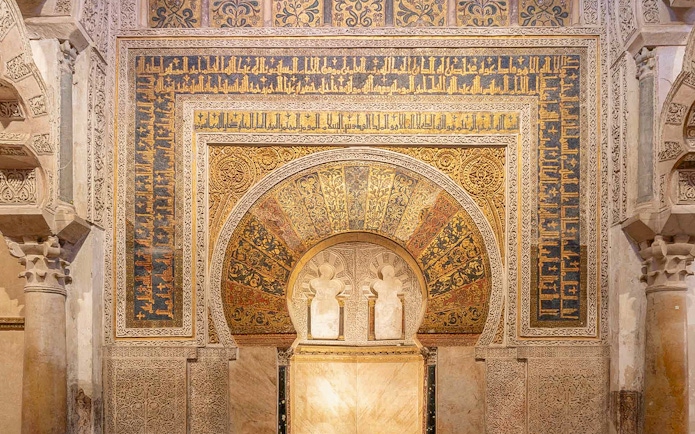 Intricate archway with Arabic calligraphy in Cordoba Mosque, Spain.