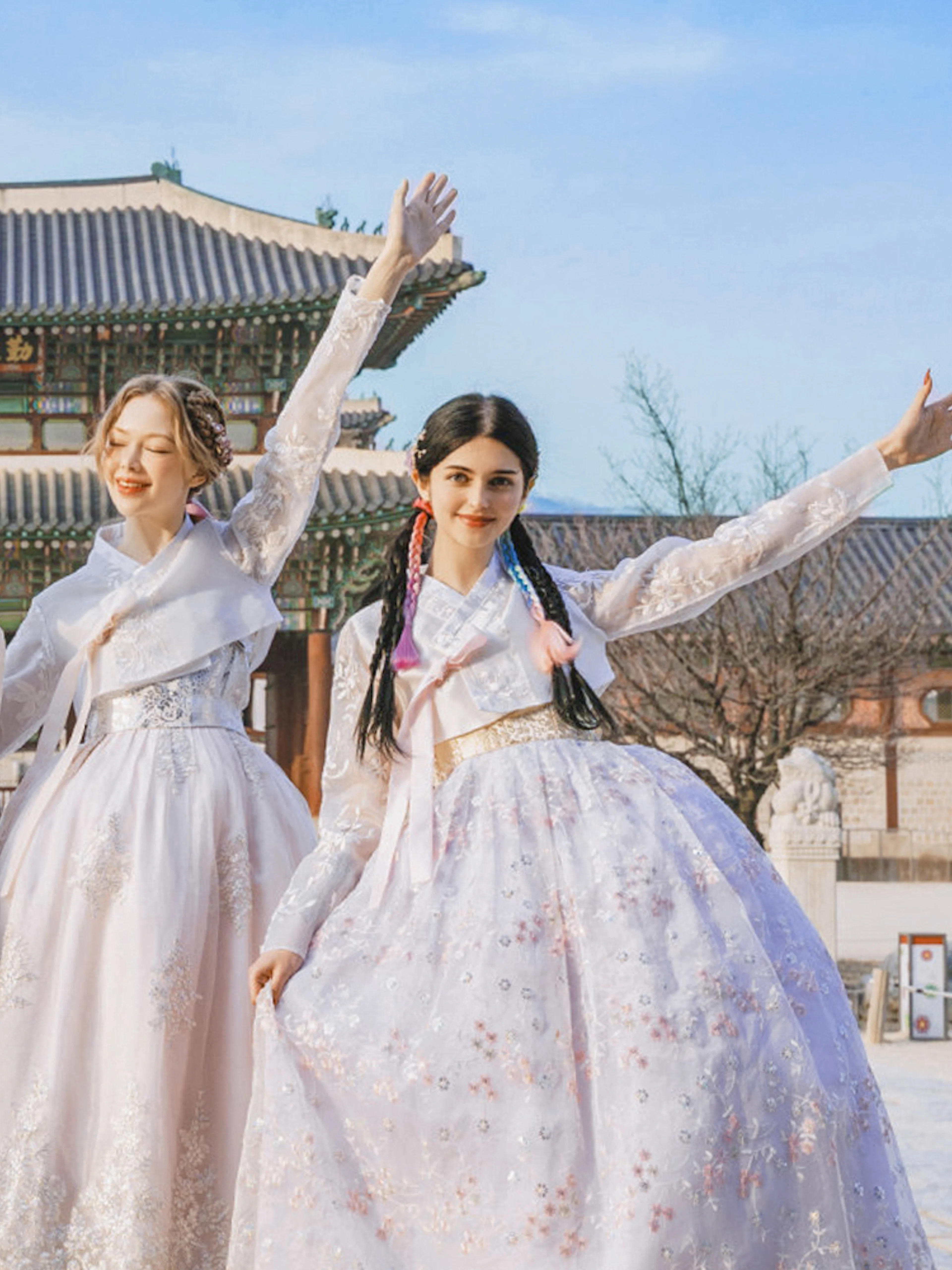 Visitors in traditional hanbok at Gyeongbokgung Palace, Seoul.