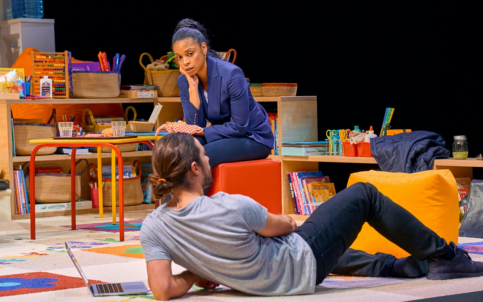 Two people in a classroom setting during a scene from Eureka Day.