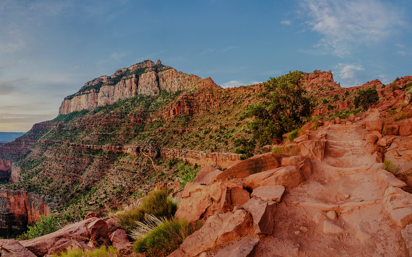 South Kaibab Trail at sunrise in Grand Canyon National Park, showcasing red rock formations.