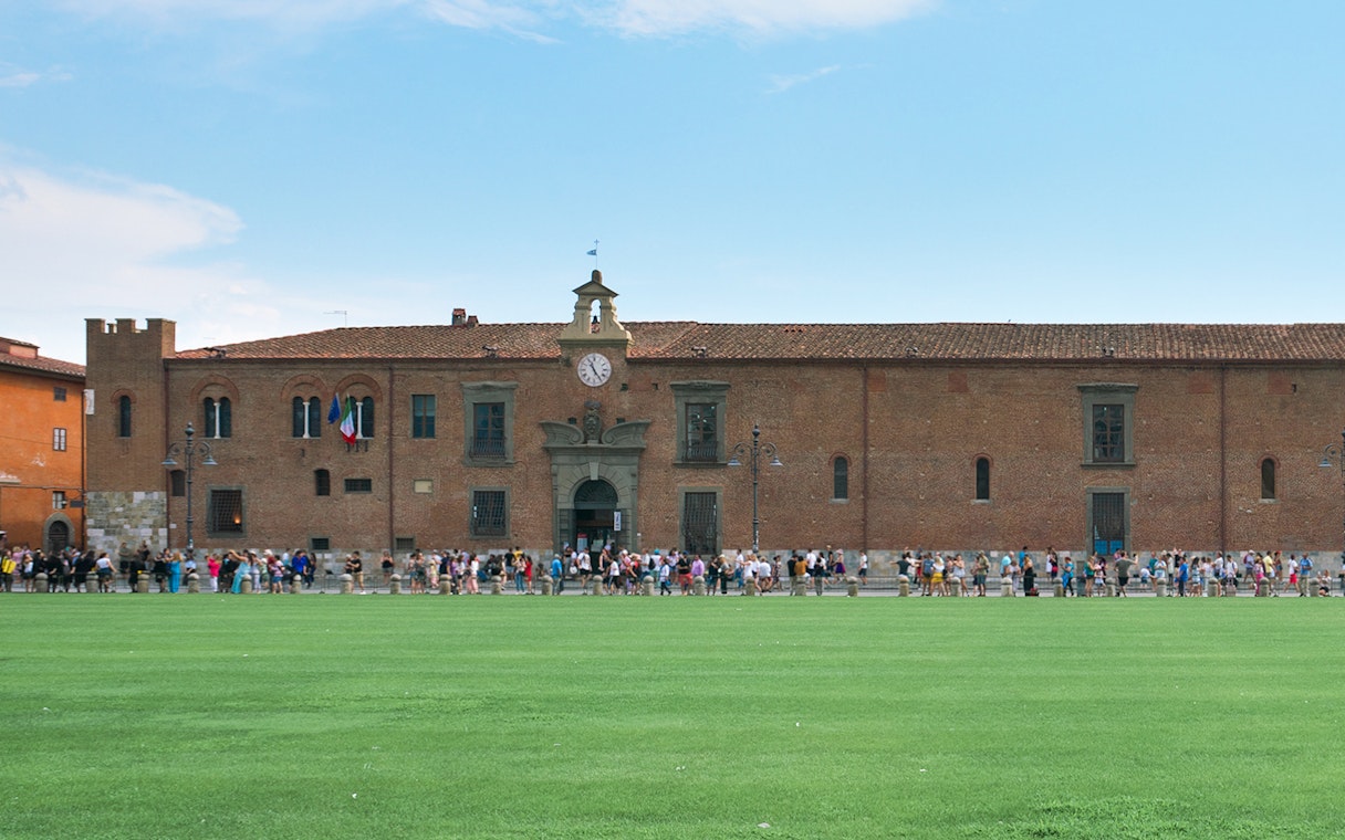 Sinopie Museum Pisa exterior with visitors and historical fresco sketches on facade.