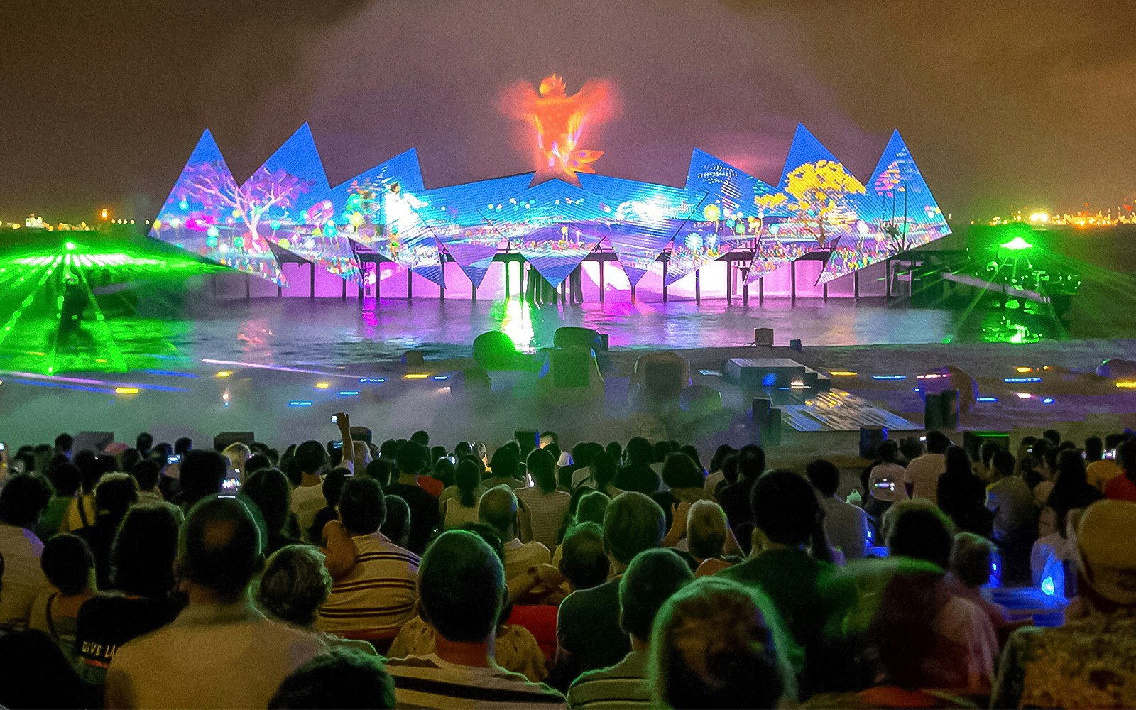 Wings of Time night show with colorful lights and water effects in Sentosa, Singapore.