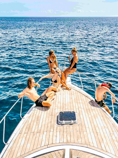 Participants relaxing on a boat during Nusa Penida & Manta Point snorkelling tour in Bali.