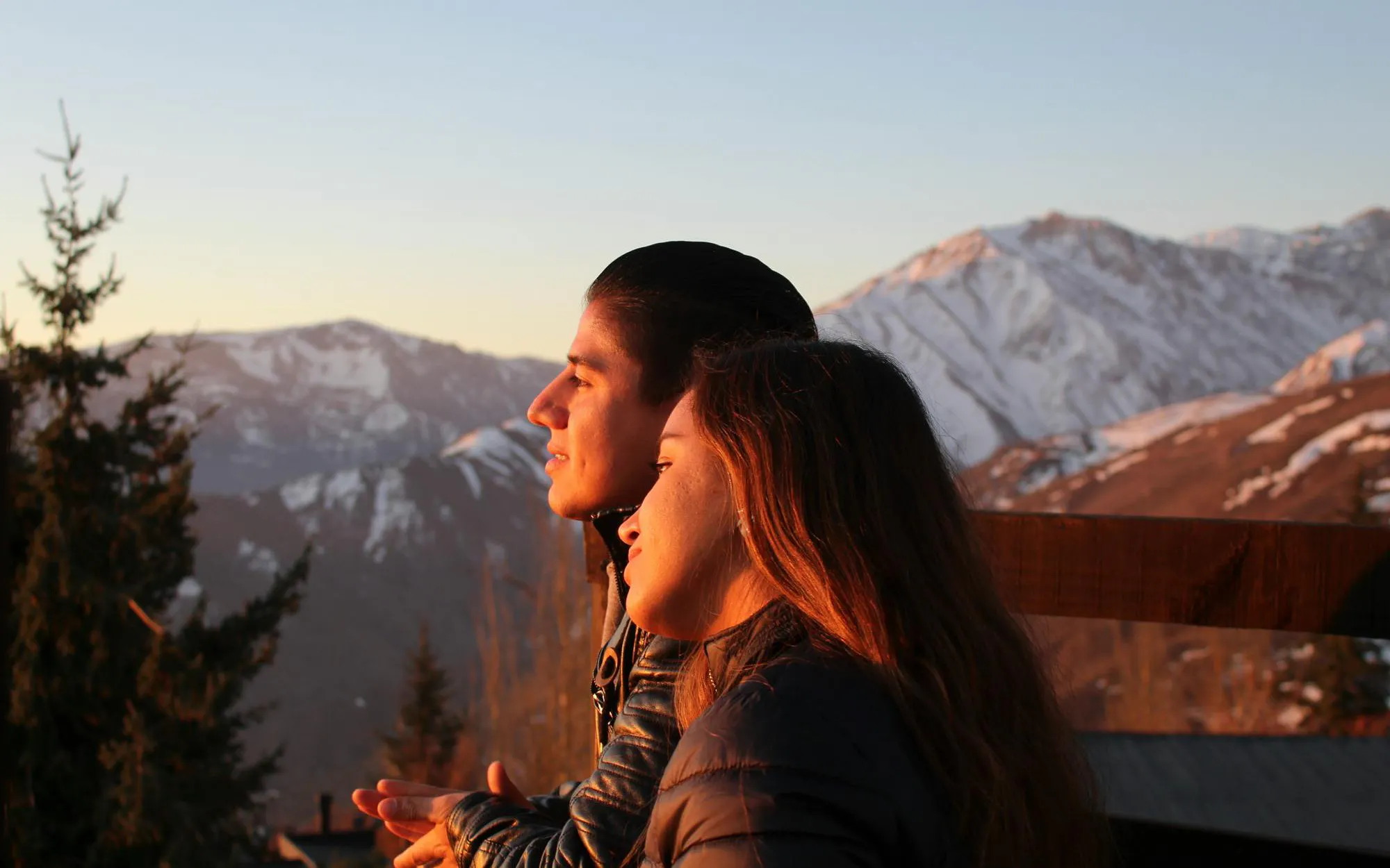 Couple admiring Andes mountains at sunset.