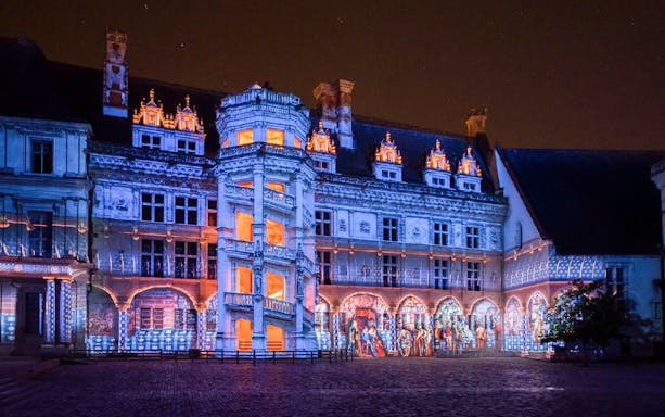 Sound and Light Show at Royal Château of Blois with illuminated facade.