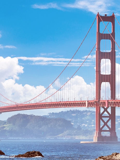 Golden Gate Bridge spanning San Francisco Bay under a clear sky.