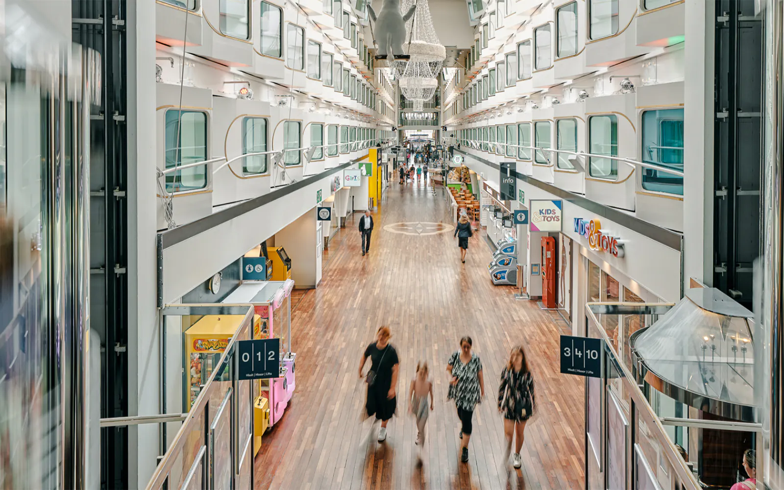 Shopping promenade on overnight ferry to Helsinki with passengers strolling.