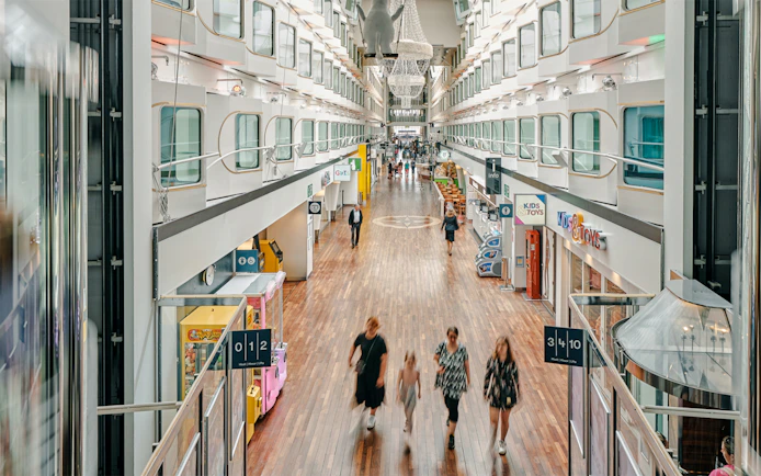Shopping promenade on overnight ferry to Helsinki with passengers strolling.