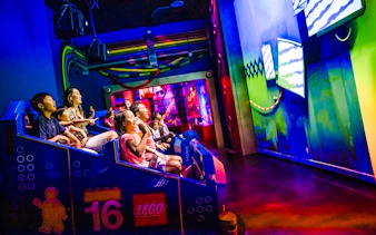 Guests enjoying a ride at Legoland New York indoor attraction.