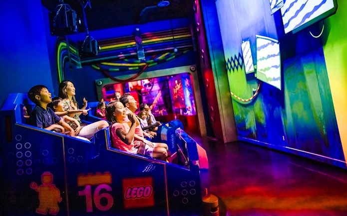 Guests enjoying a ride at Legoland New York indoor attraction.