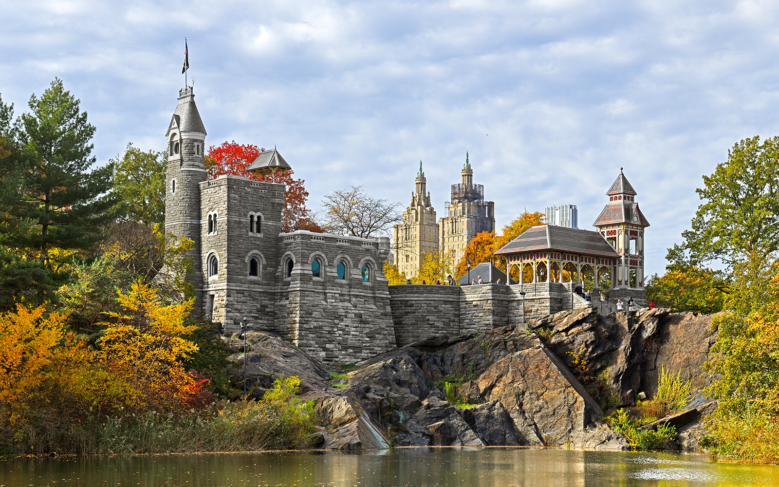 Belvedere Castle overlooking Turtle Pond in Central Park, New York City, with autumn foliage.