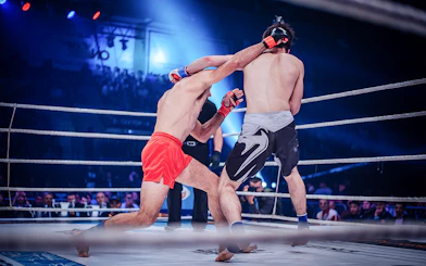 Muay Thai fighters in action at Patong Boxing Stadium, Thailand.