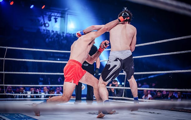 Muay Thai fighters in action at Patong Boxing Stadium, Thailand.