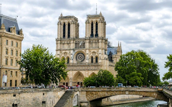 Notre-Dame Cathedral with Seine River bridge in Paris, part of the Treasure Hunt tour from the Panthéon to the Louvre.