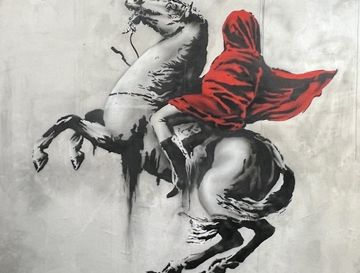 Banksy artwork of a hooded figure on a rearing horse at Amsterdam museum.