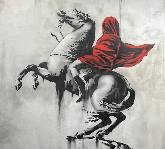 Banksy artwork of a hooded figure on a rearing horse at Amsterdam museum.