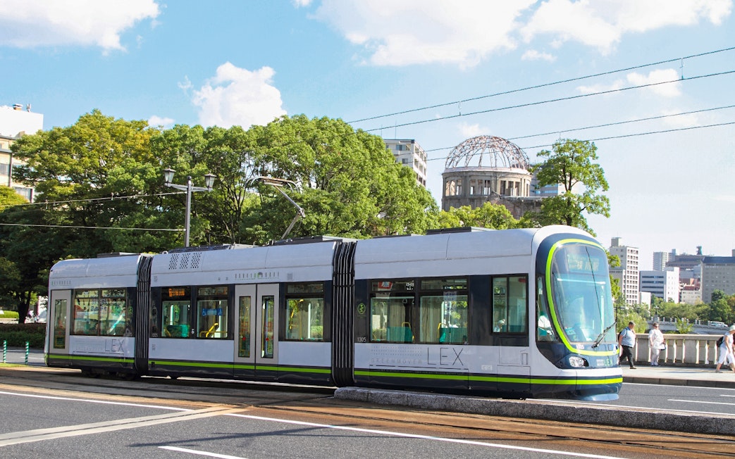 Tram passing by Hiroshima Peace Memorial in Hiroshima, Japan.