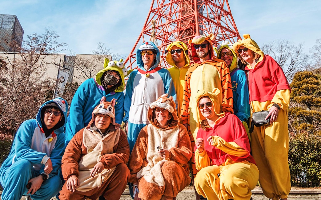 Group in costumes posing on Tokyo Shibuya Street for Go-Kart Experience.