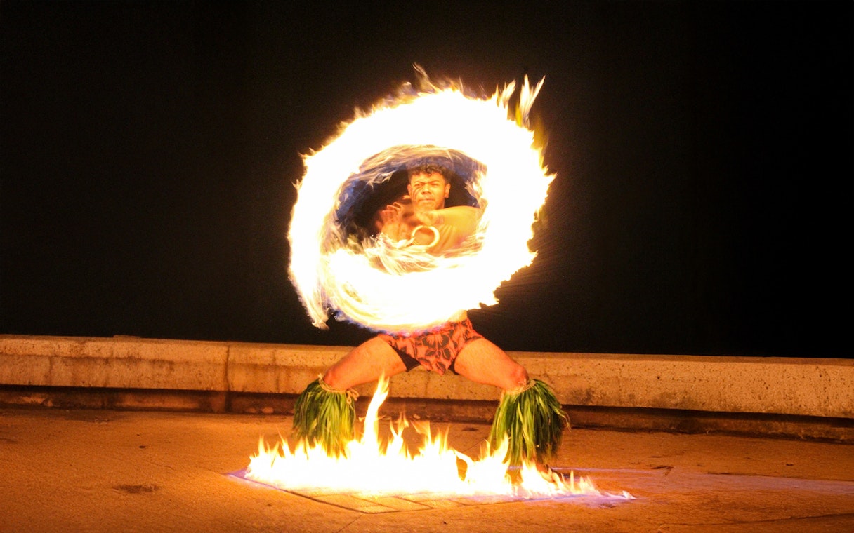 Fire dancer performing at Moana Luau, Hawaii.
