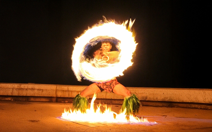Fire dancer performing at Moana Luau, Hawaii.