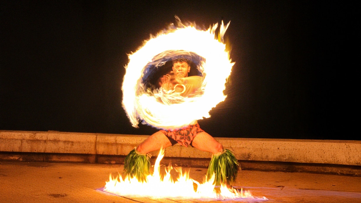 Fire dancer performing at Moana Luau, Hawaii.