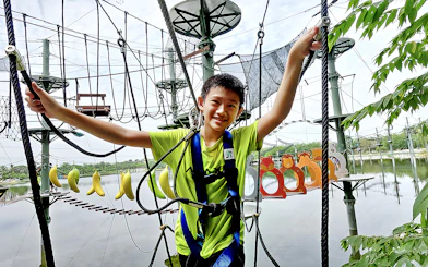 Child navigating ropes course at ESCAPE Ipoh Theme Park, Malaysia.