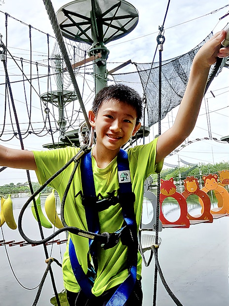 Child navigating ropes course at ESCAPE Ipoh Theme Park, Malaysia.